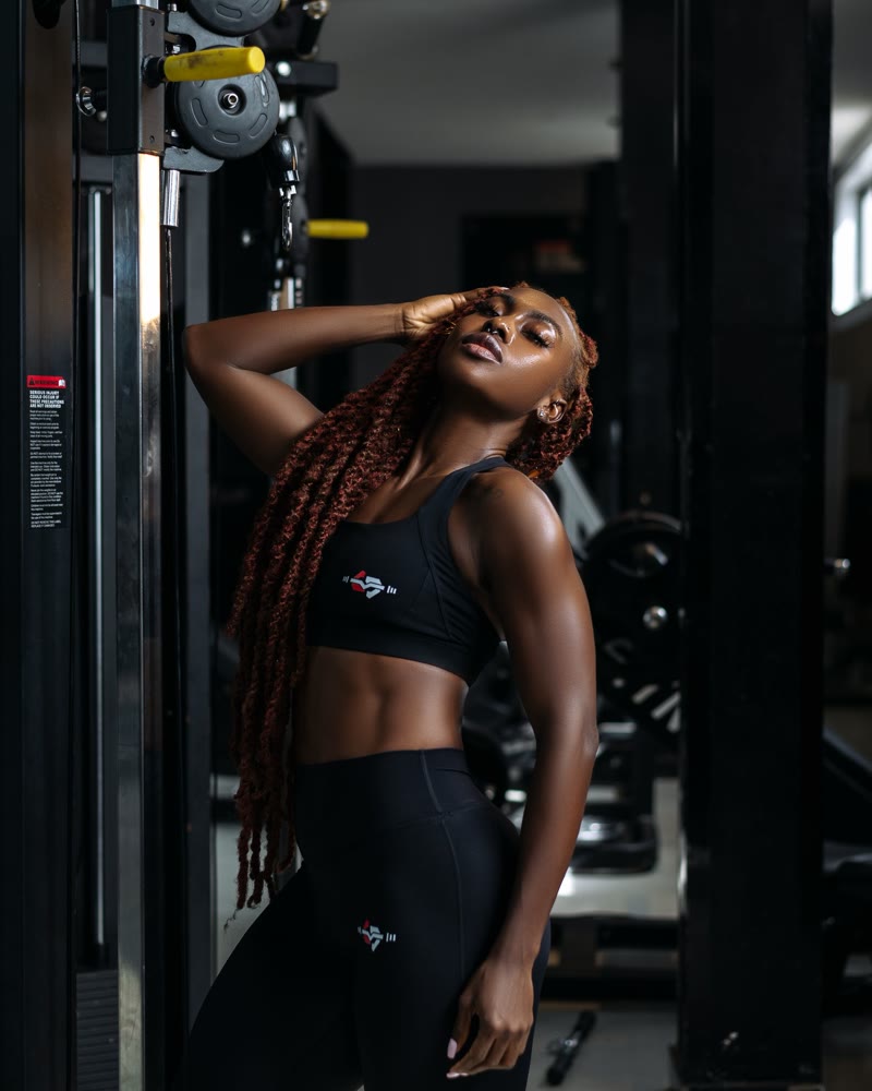 Coach Jules beside strength-training equipment