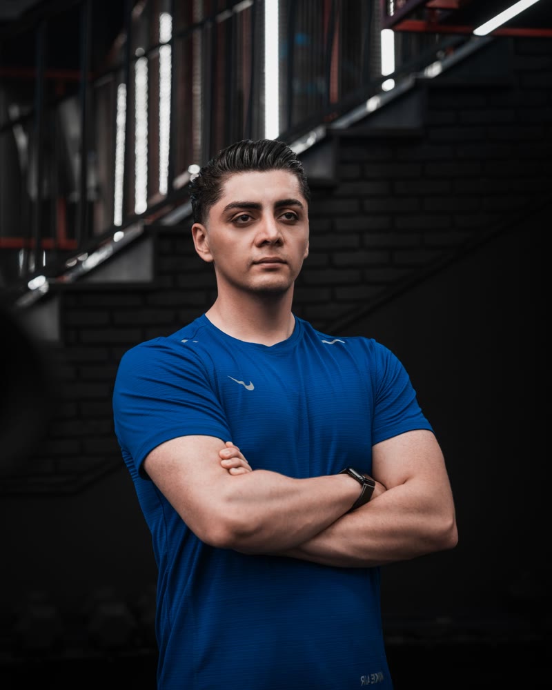 Conditioning coach Miles standing with folded arms in the gym