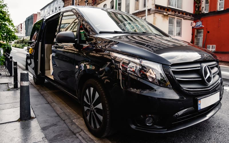 Black Mercedes V-Class executive MPV with its passenger door open
